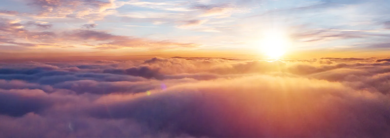 Sunset sky above clouds with dramatic light.