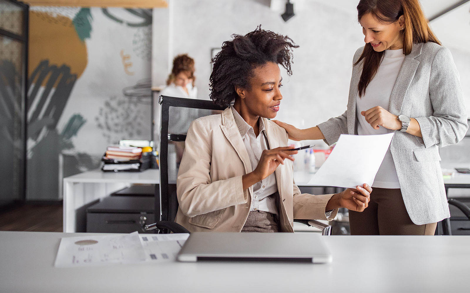 Business woman discussing opportunities with co-worker