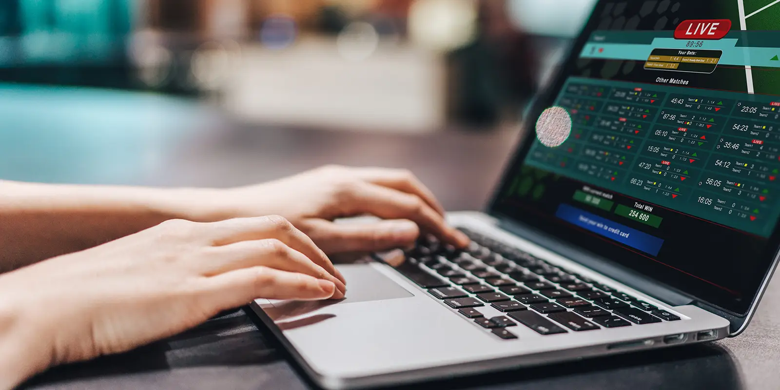 Female sitting in loft coffee shop and making bets online on sport bookmaker