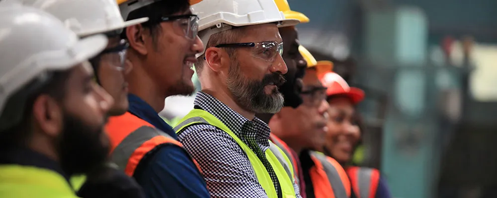 Group of manufacturing workers looking in the same direction