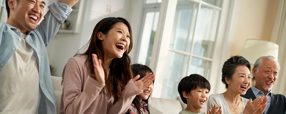 people watching something smiling and clapping