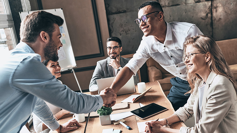 Group of business people looking over documents smiling