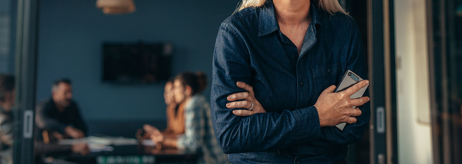 business woman standing in office discussing succession planning