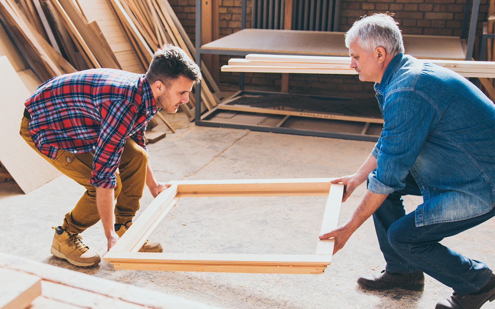 Carpenters holding window frame final product