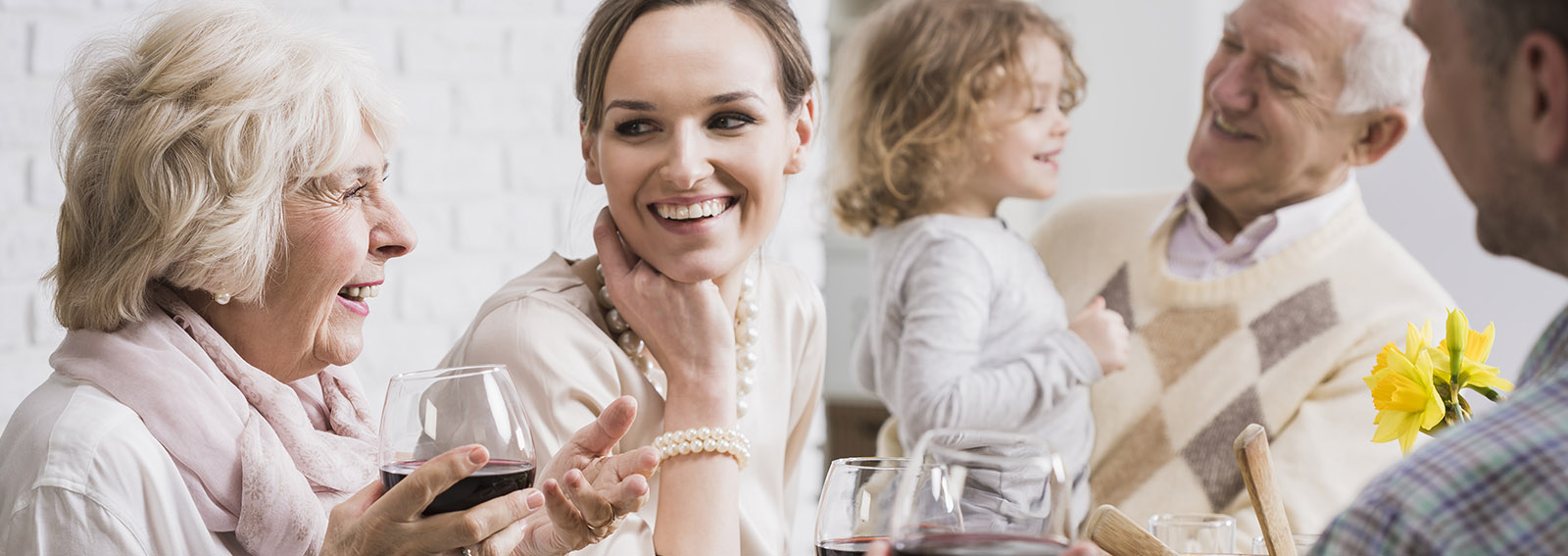 Daughter laughing with her mother at a family gathering