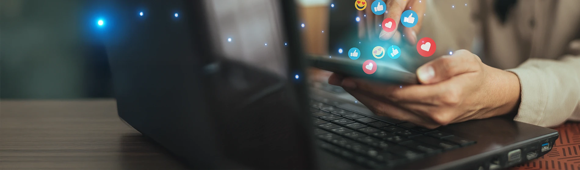 Hands holding and typing  on smartphone to communicate with emoji media icons