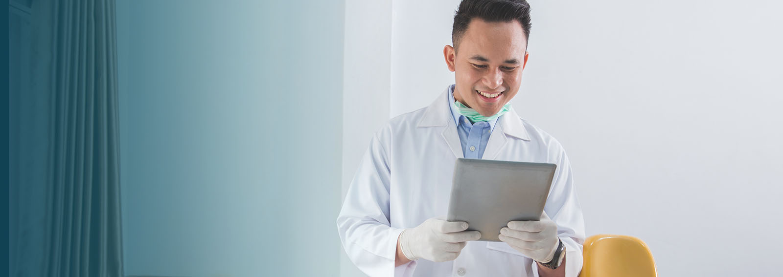 dentist in an office working on a tablet