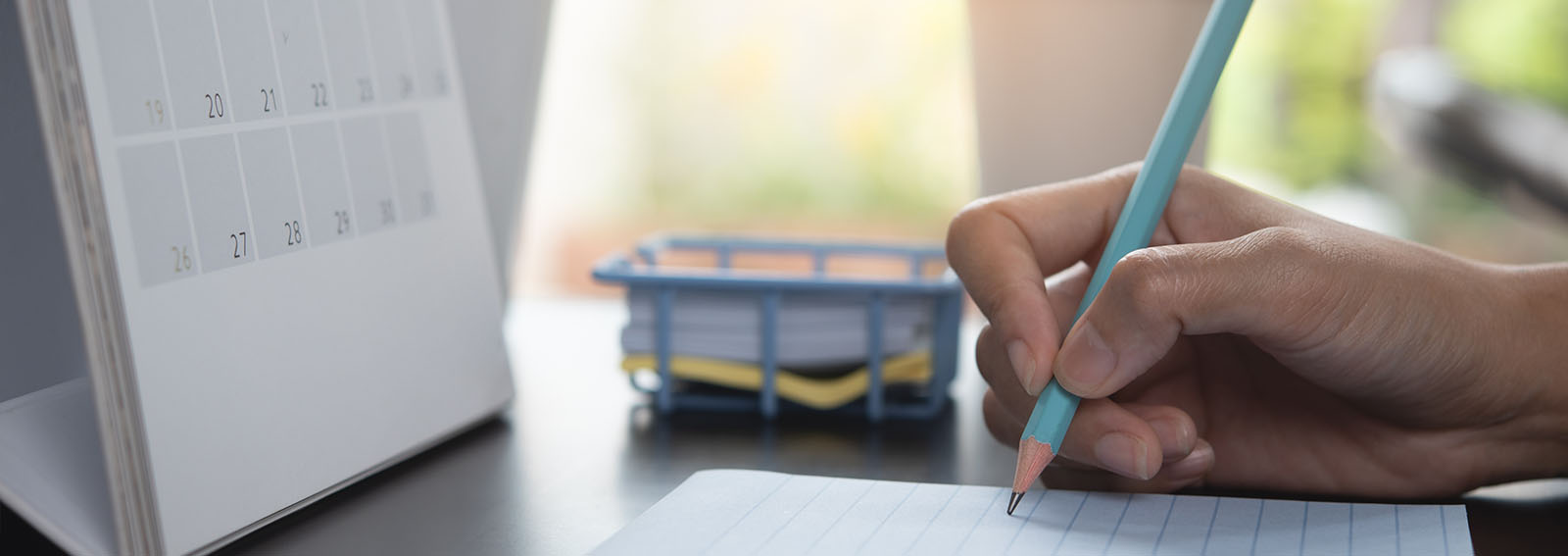 Close-up of a woman writing notes in an office