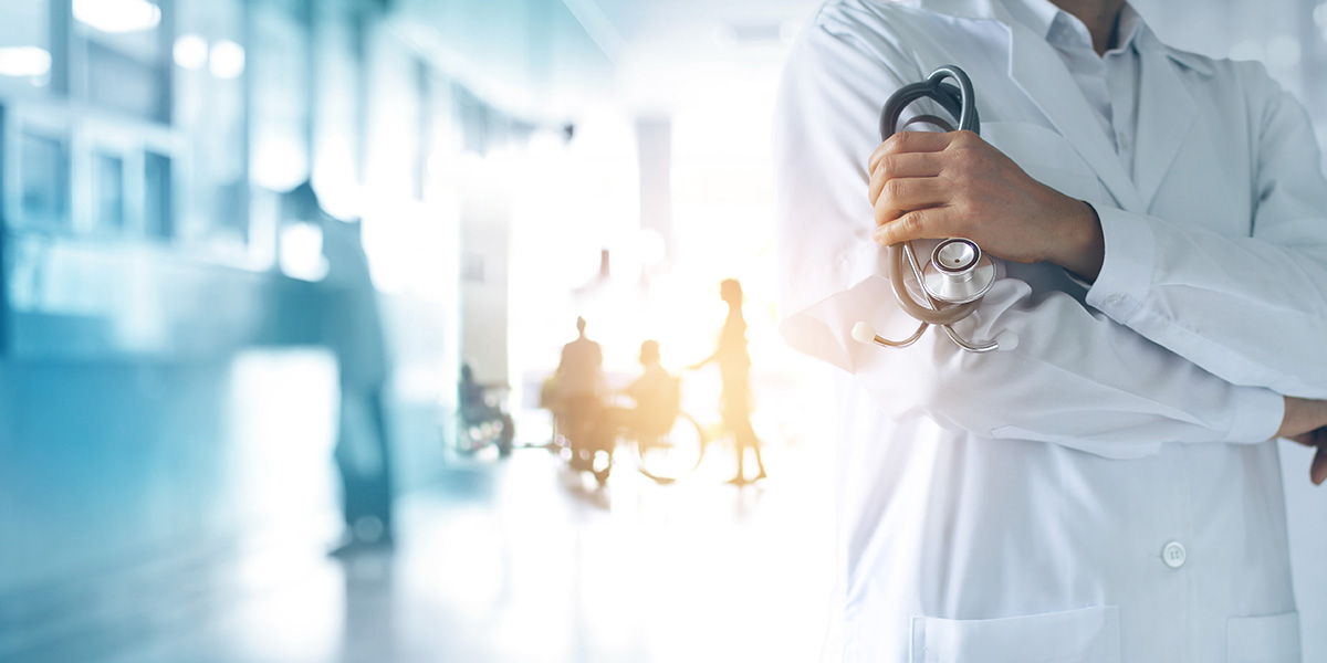 Doctor in hallway holding stethoscope