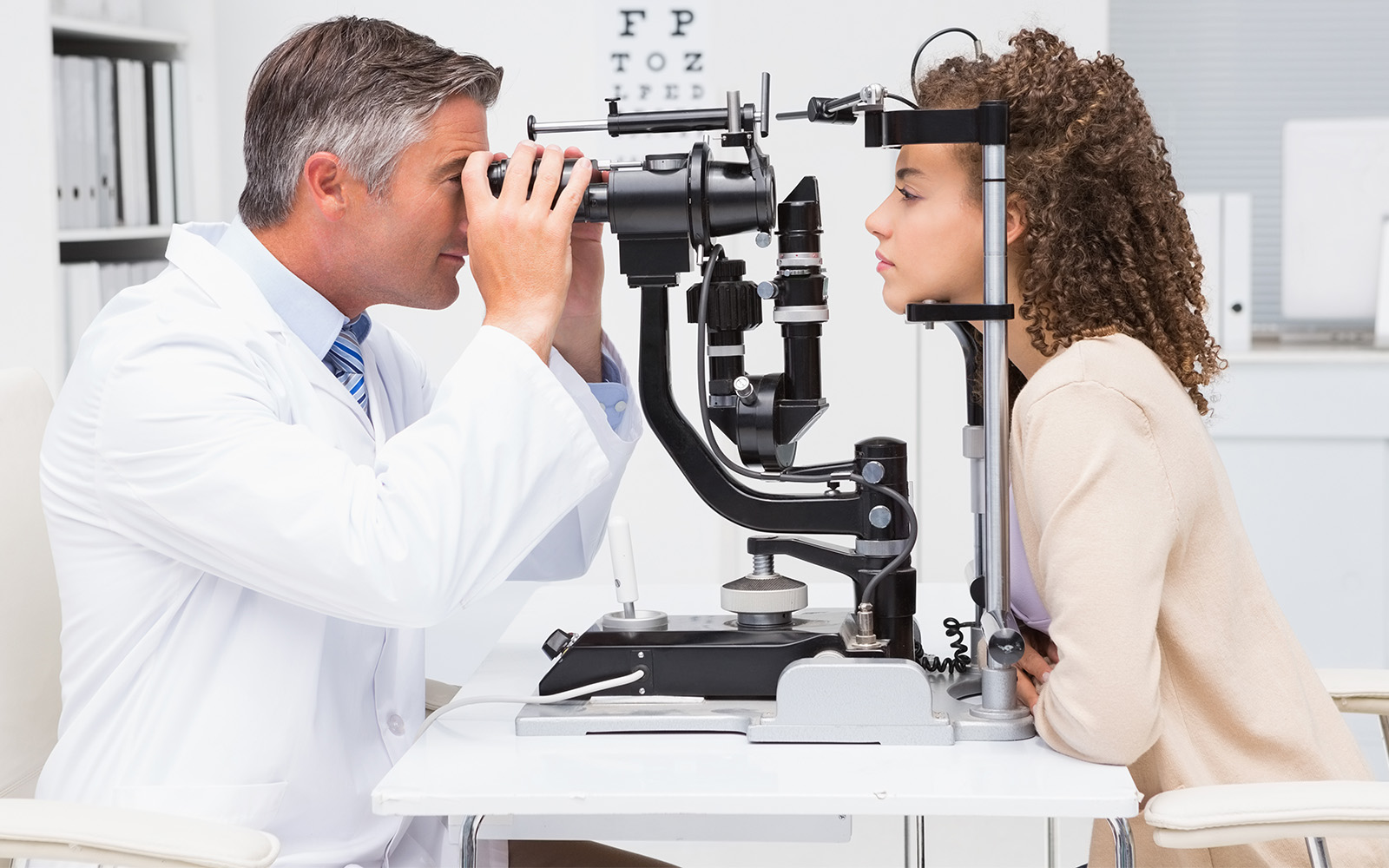 Woman doing eye test with optometrist in medical office