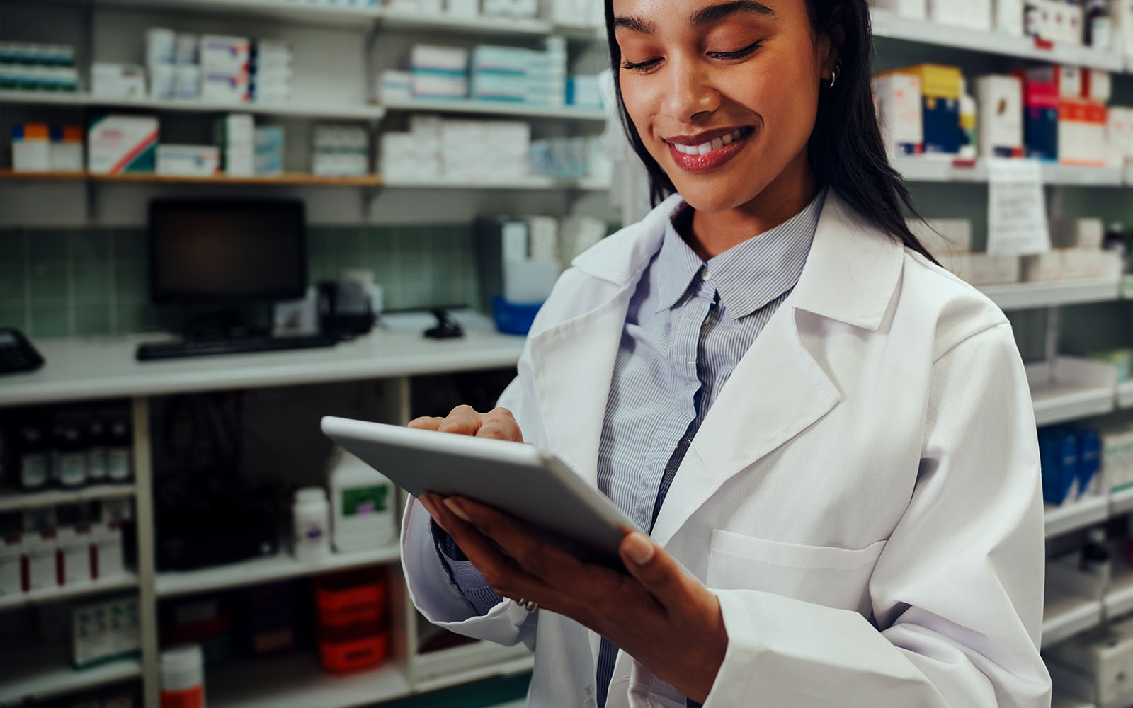 pharmacy owner working in pharmacy using digital tablet