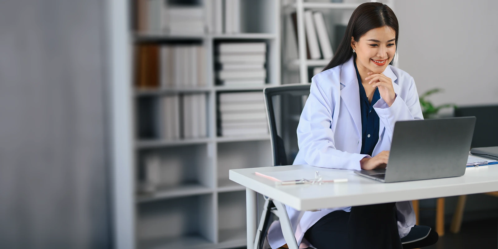 young professional working on a laptop in a modern office