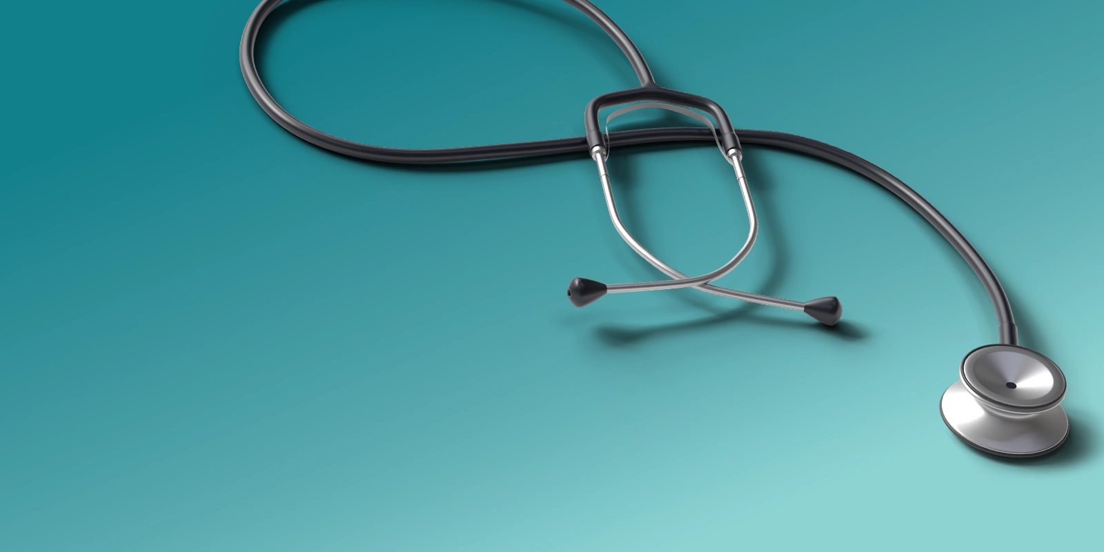 Stethoscope resting on a teal background, viewed from above.