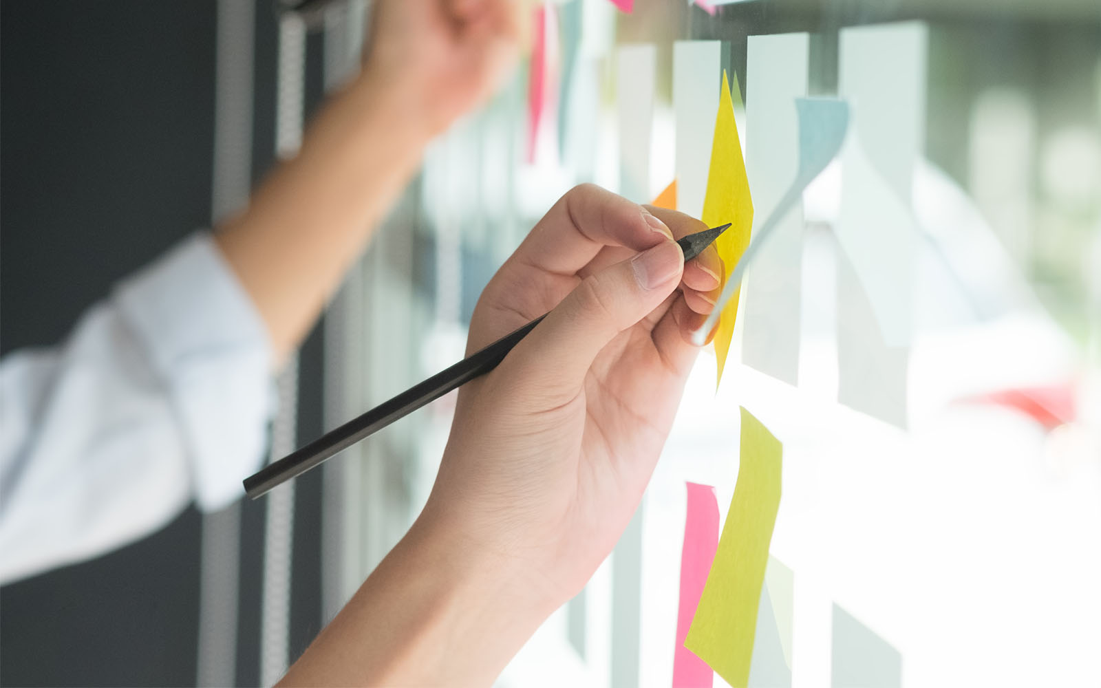 Writing on a window full of sticky notes