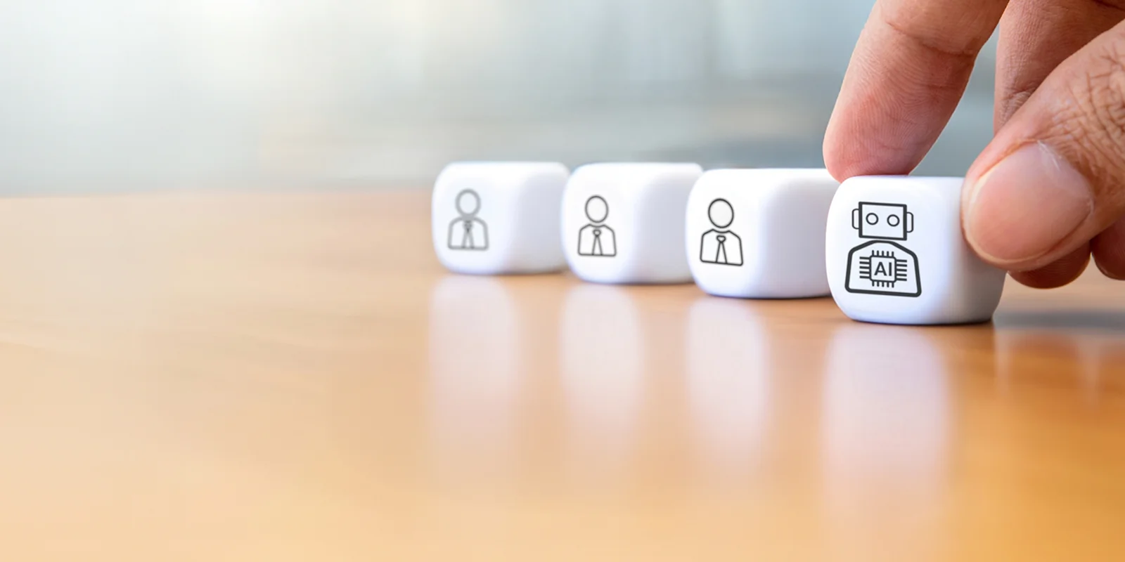 Hand picking cube with a robot AI icon next to three cubes with human icons