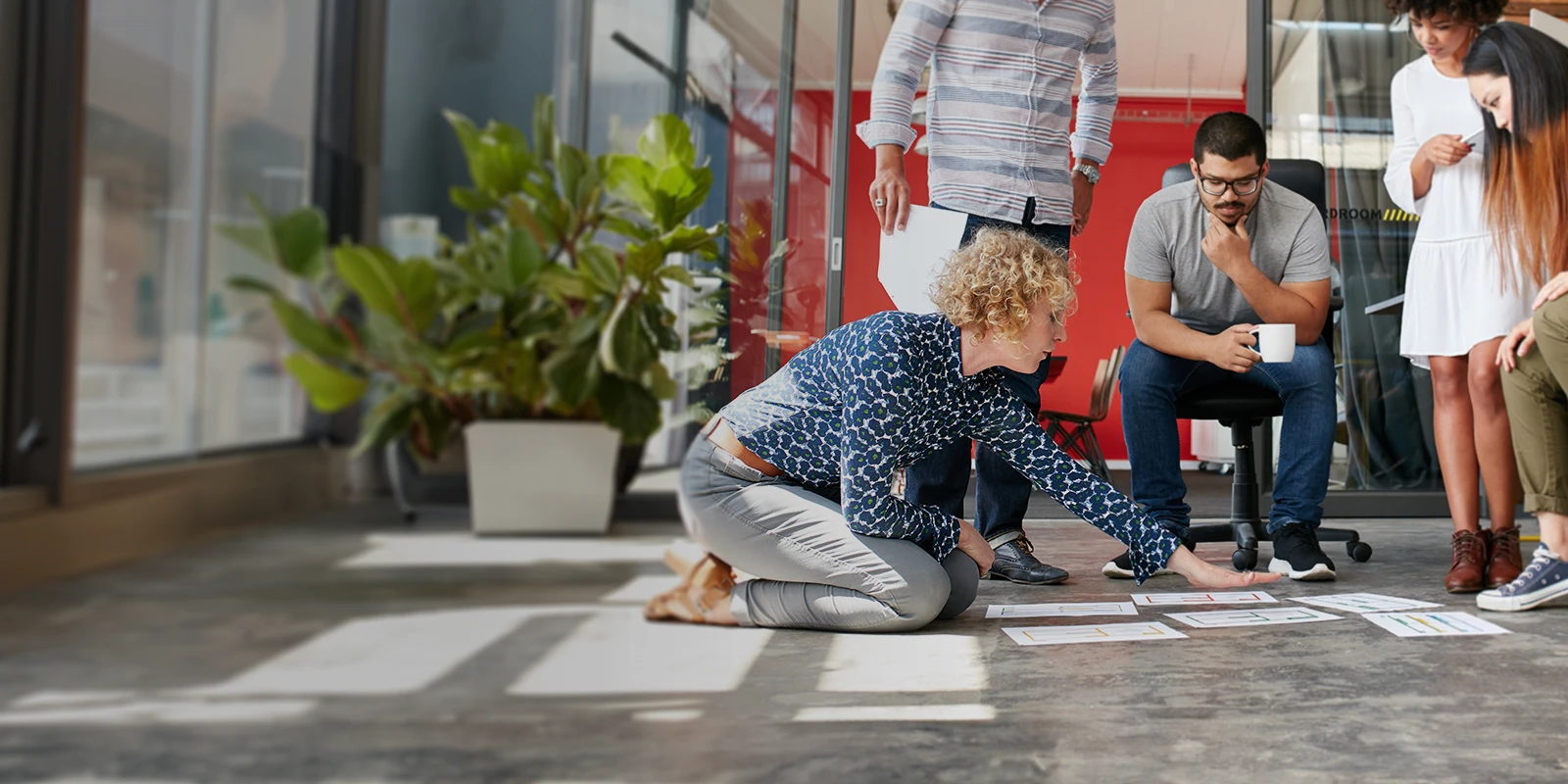 Three workers collaborating with one another in an office building.