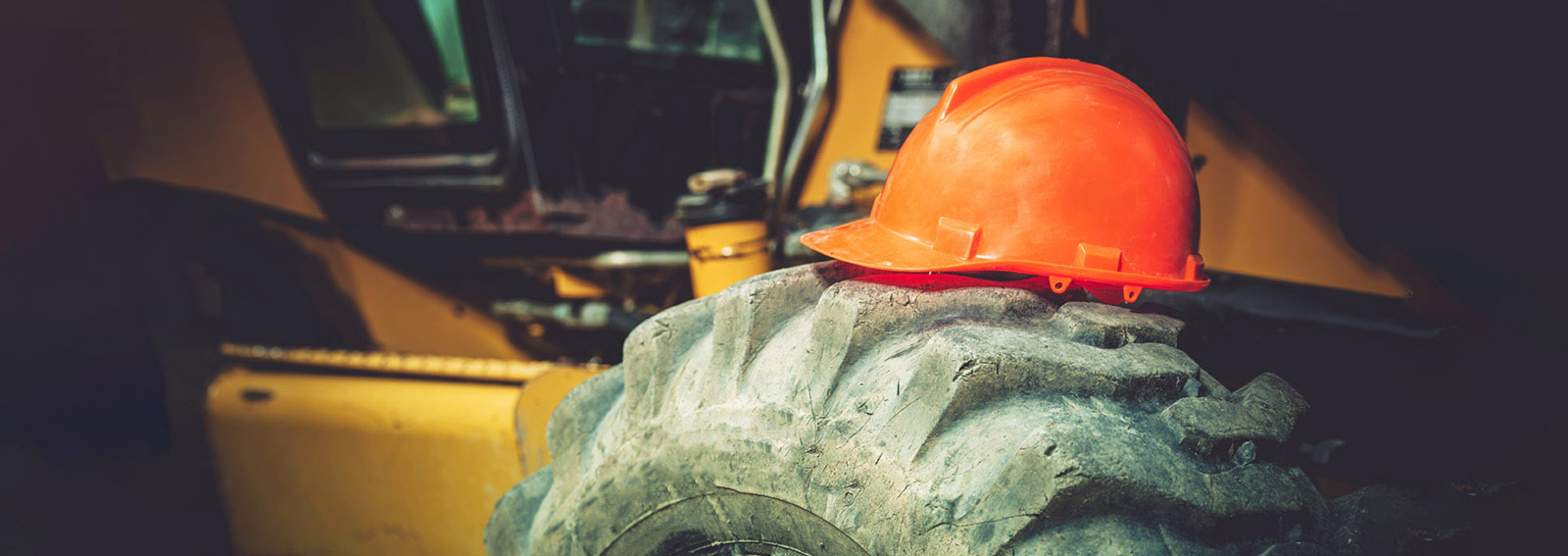A construction hat sitting on a tractor tire
