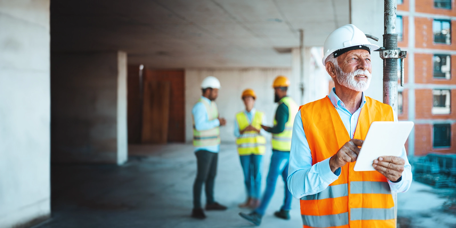 construction owner on site with employees in the background