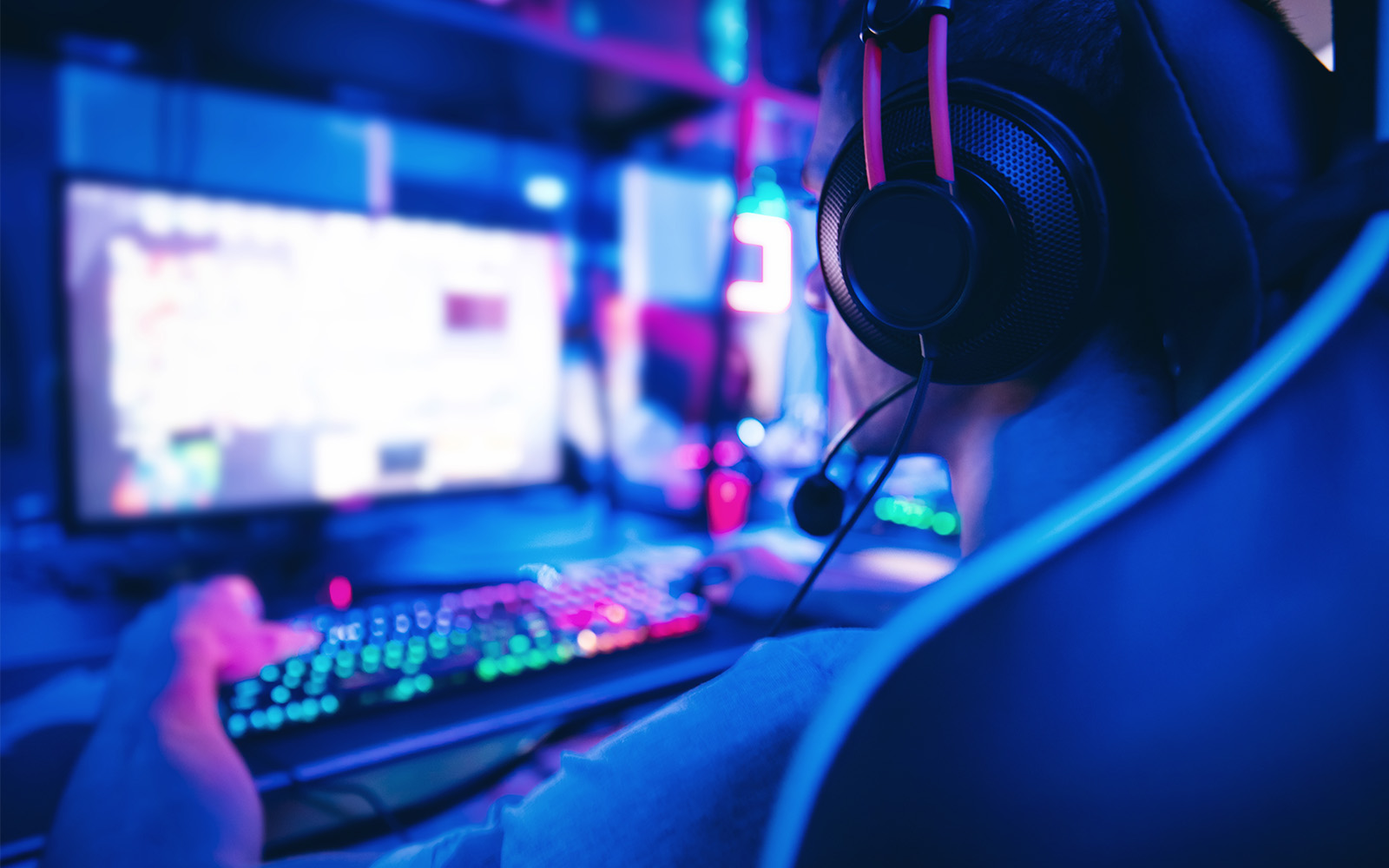 person working on a computer wearing a headset