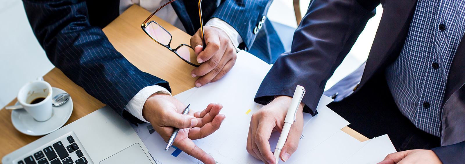 Two business people writing out a place on paper