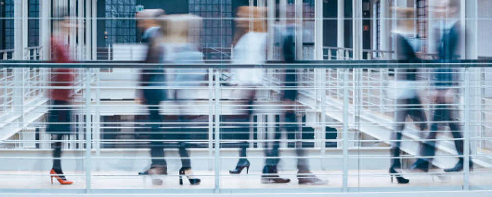 Blurred professionals walking in a hallway