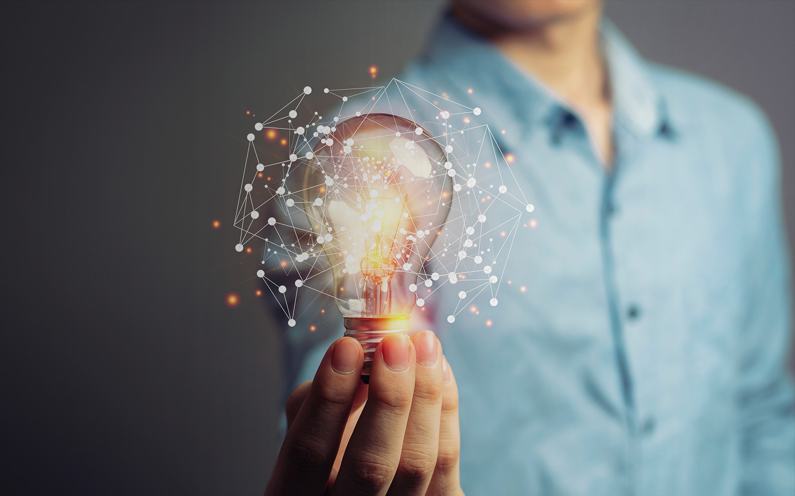 man holding bright bulb