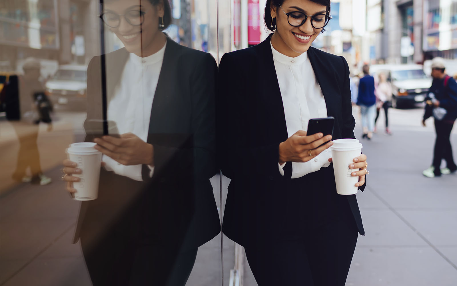 business person using smartphone on busy street