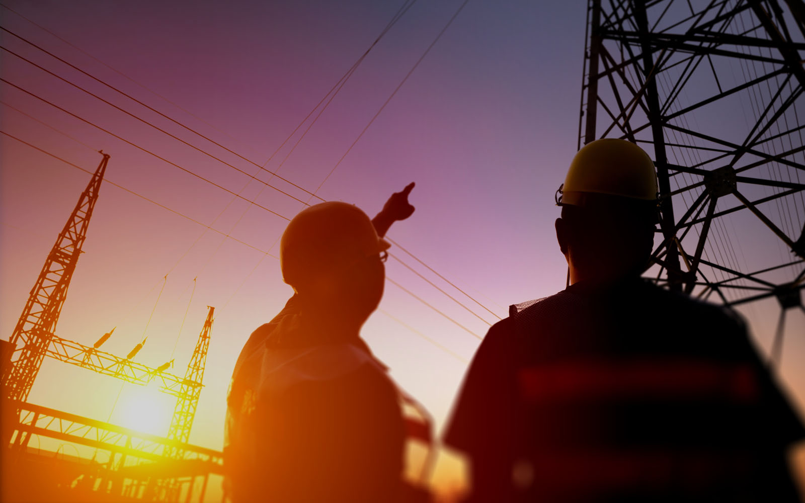 electrical workers looking at power station