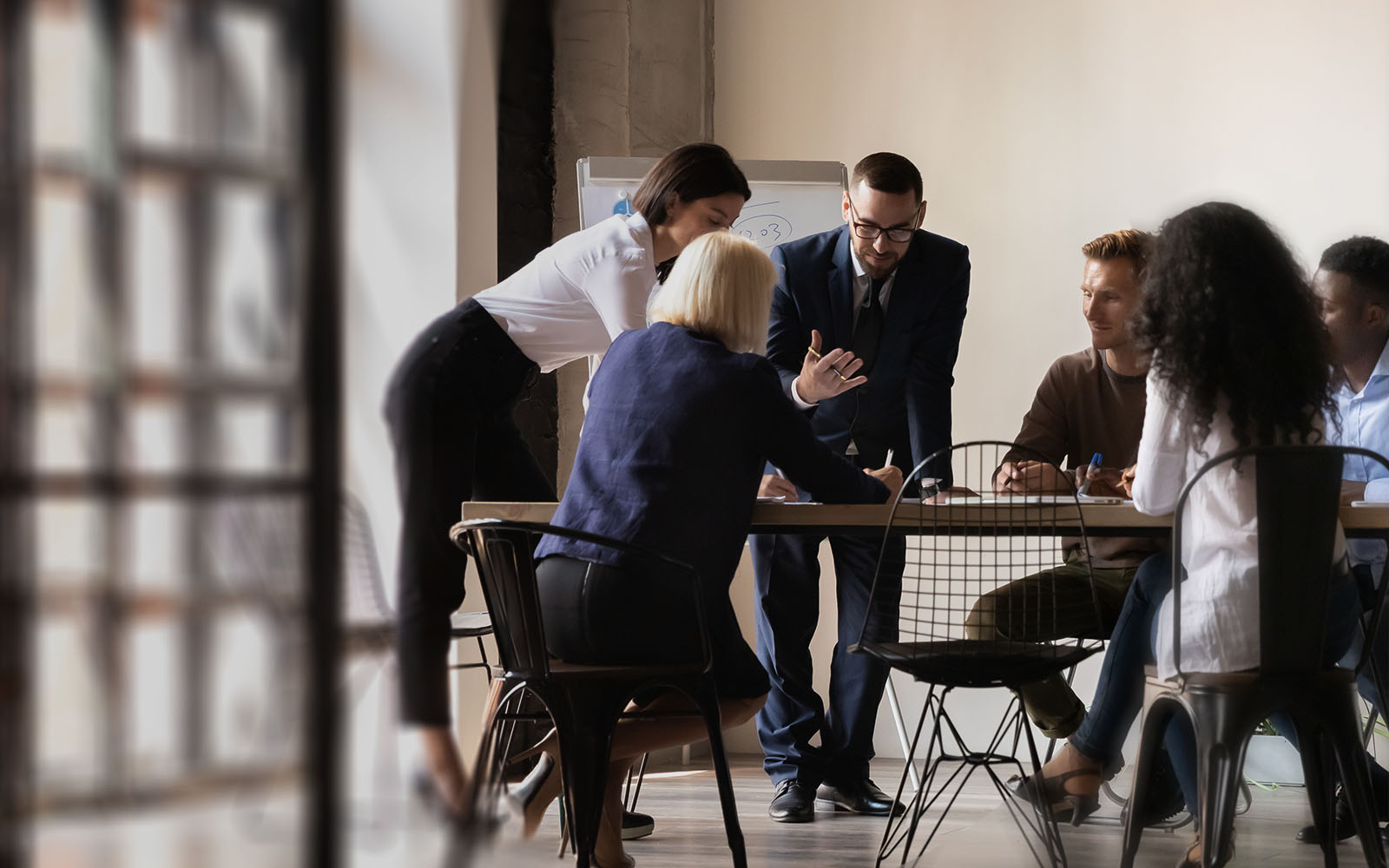 Diverse employees team engaged in teamwork in boardroom jpg