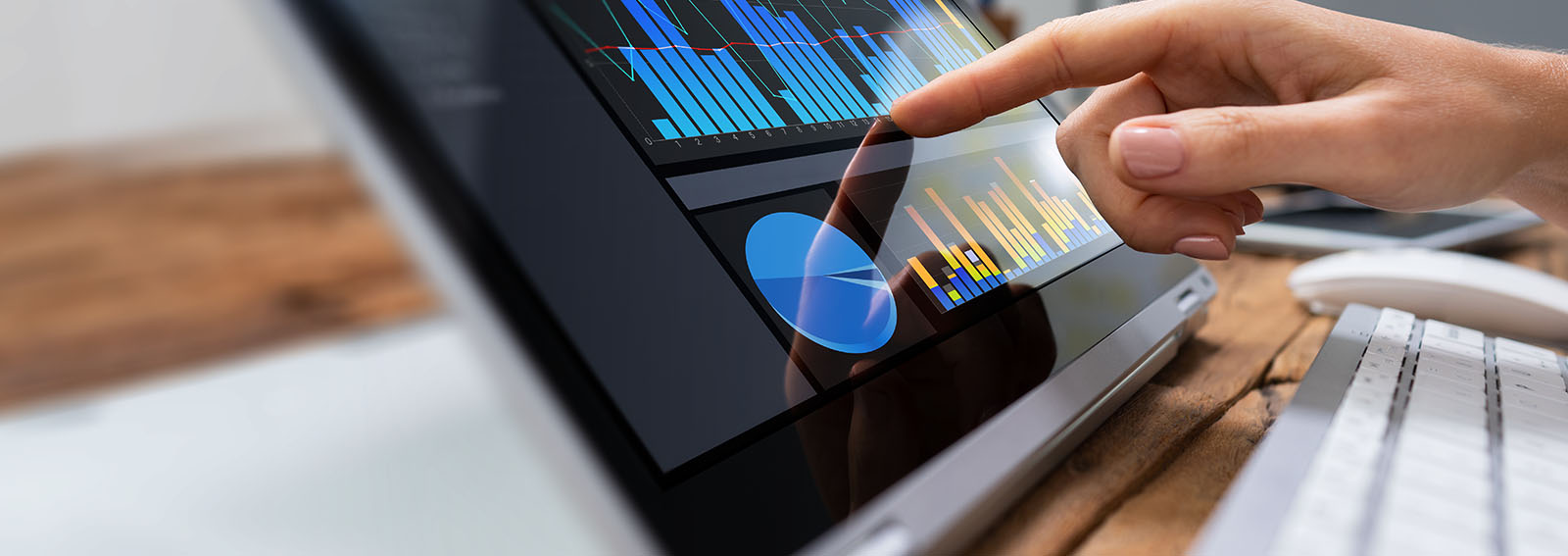 business woman pointing at a dashboard on a tablet