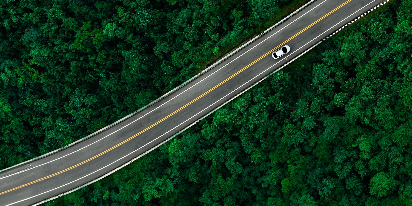 Aerial view of a car driving down a winding road