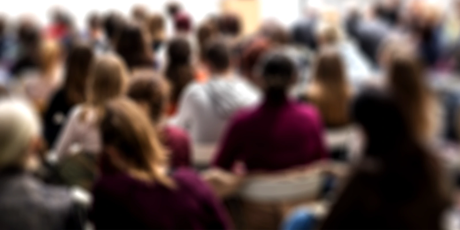audience engaged at a conference listening to speakers