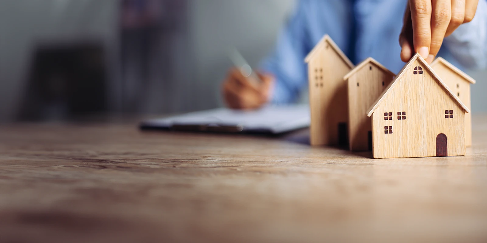 urban planner at a desk with wooden house models