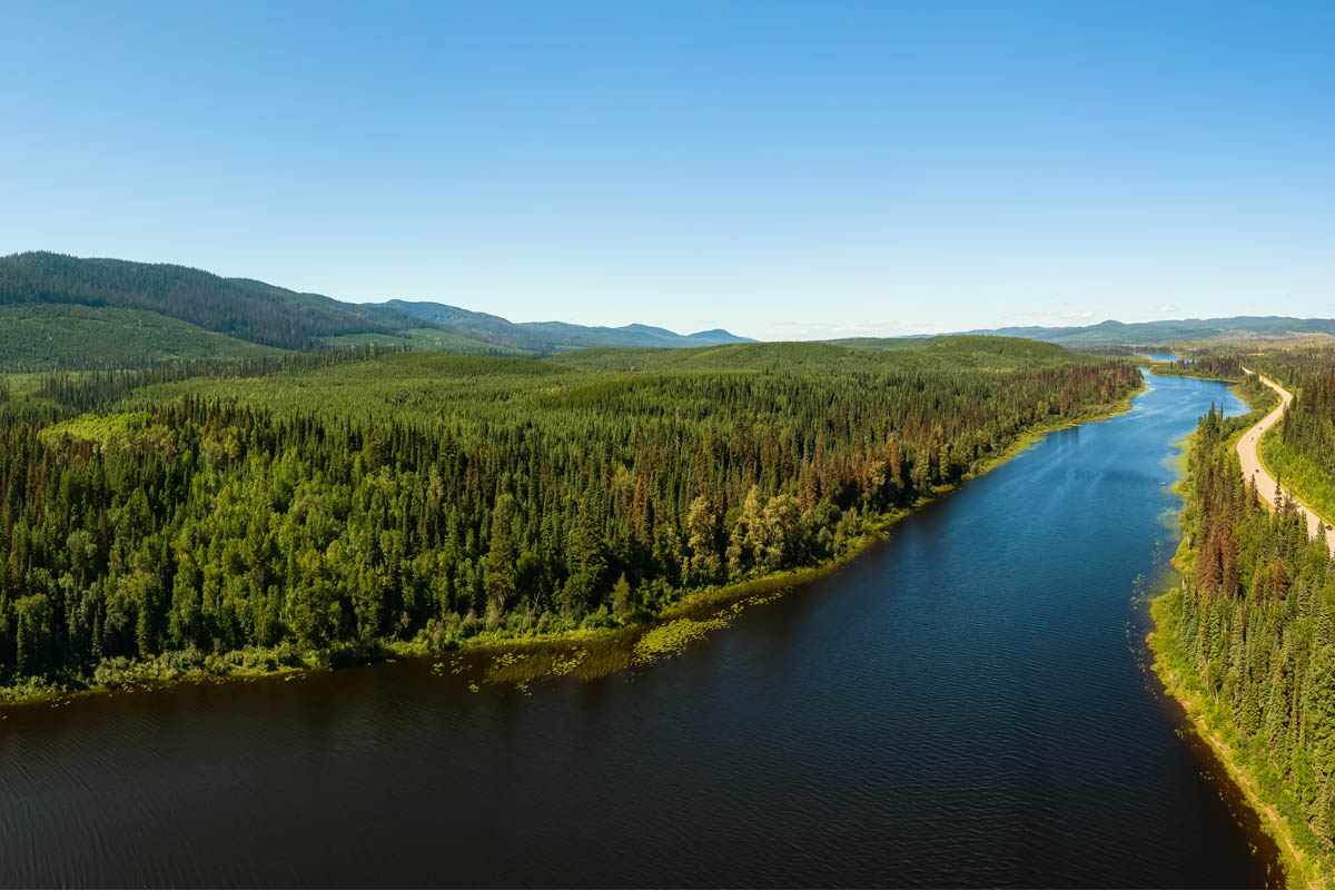Wide river cutting through beautiful forested landscape
