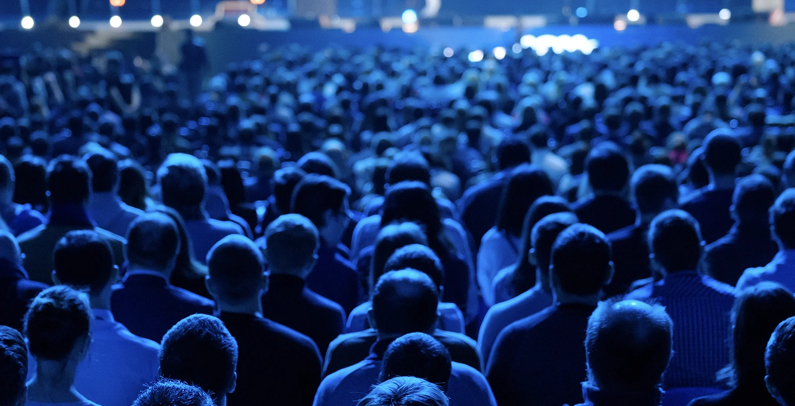 Audience listens to a preseneter in a conference hall