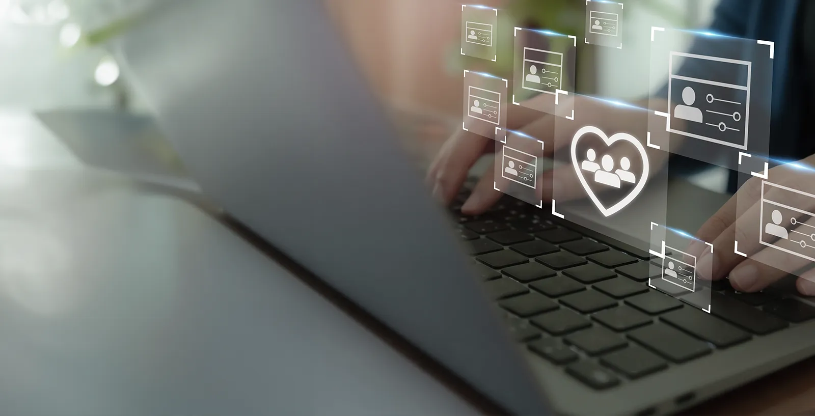 person typing on a laptop with an icon of a heart over the image