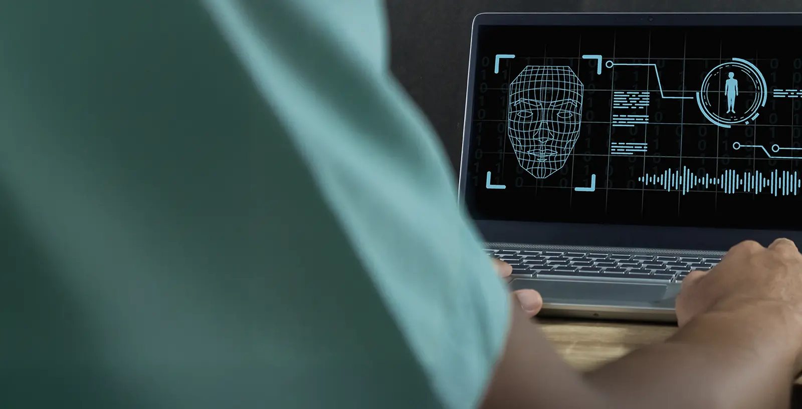 Man on laptop using deepfake technology