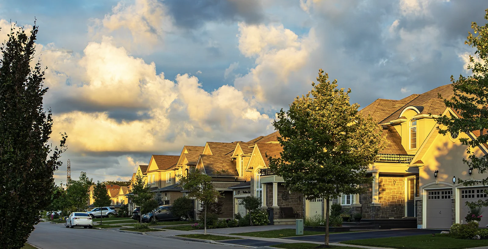 Suburban street with lots of clouds in the sky