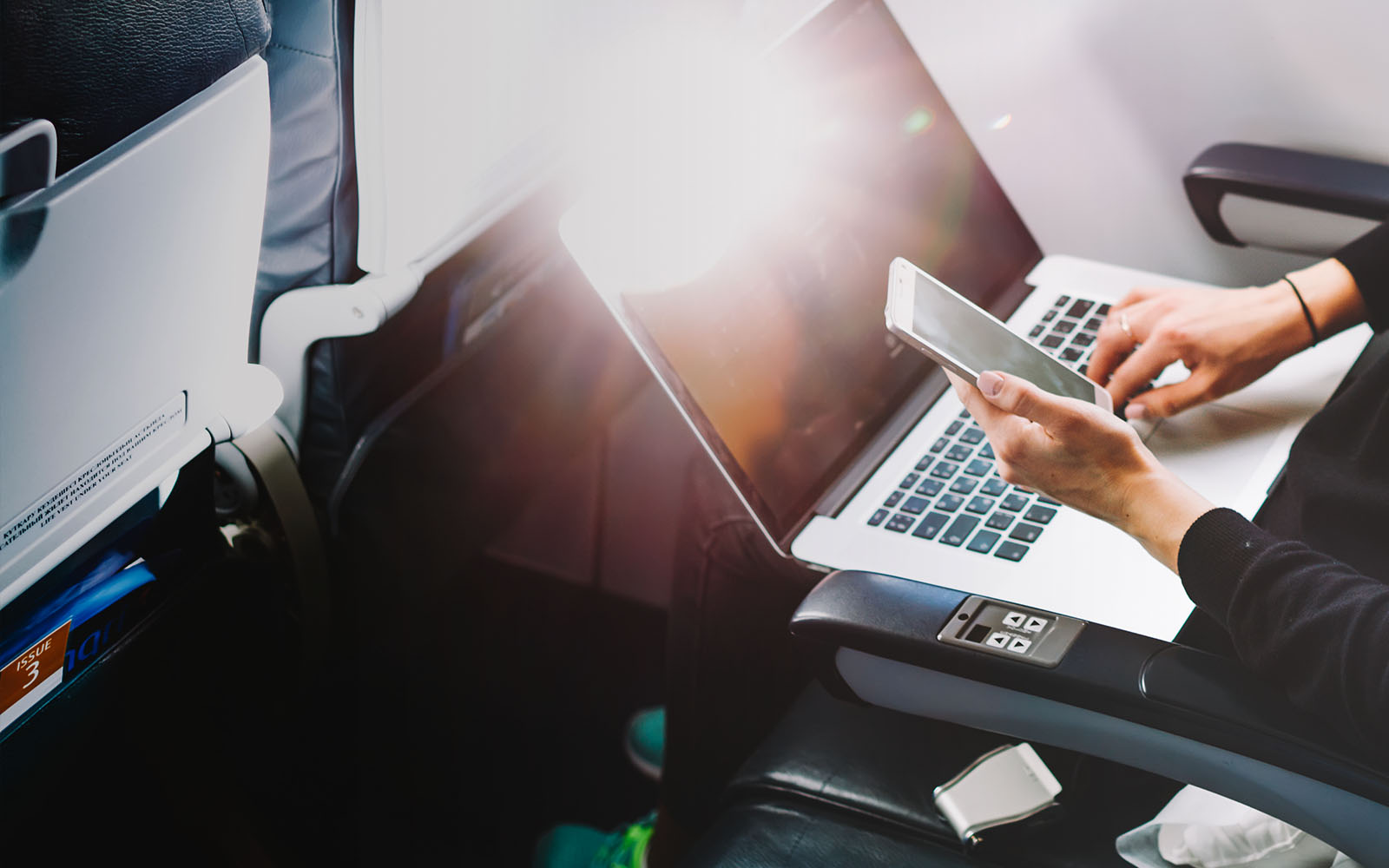 business woman working on a latop on a plane