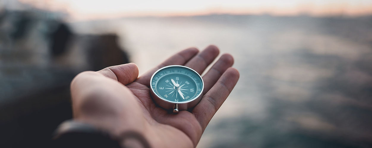 Close up of someone holding a compass 