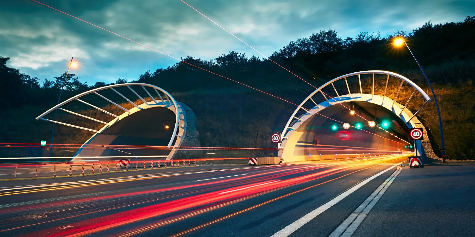 Highway with tunnels and vehicle light trails.