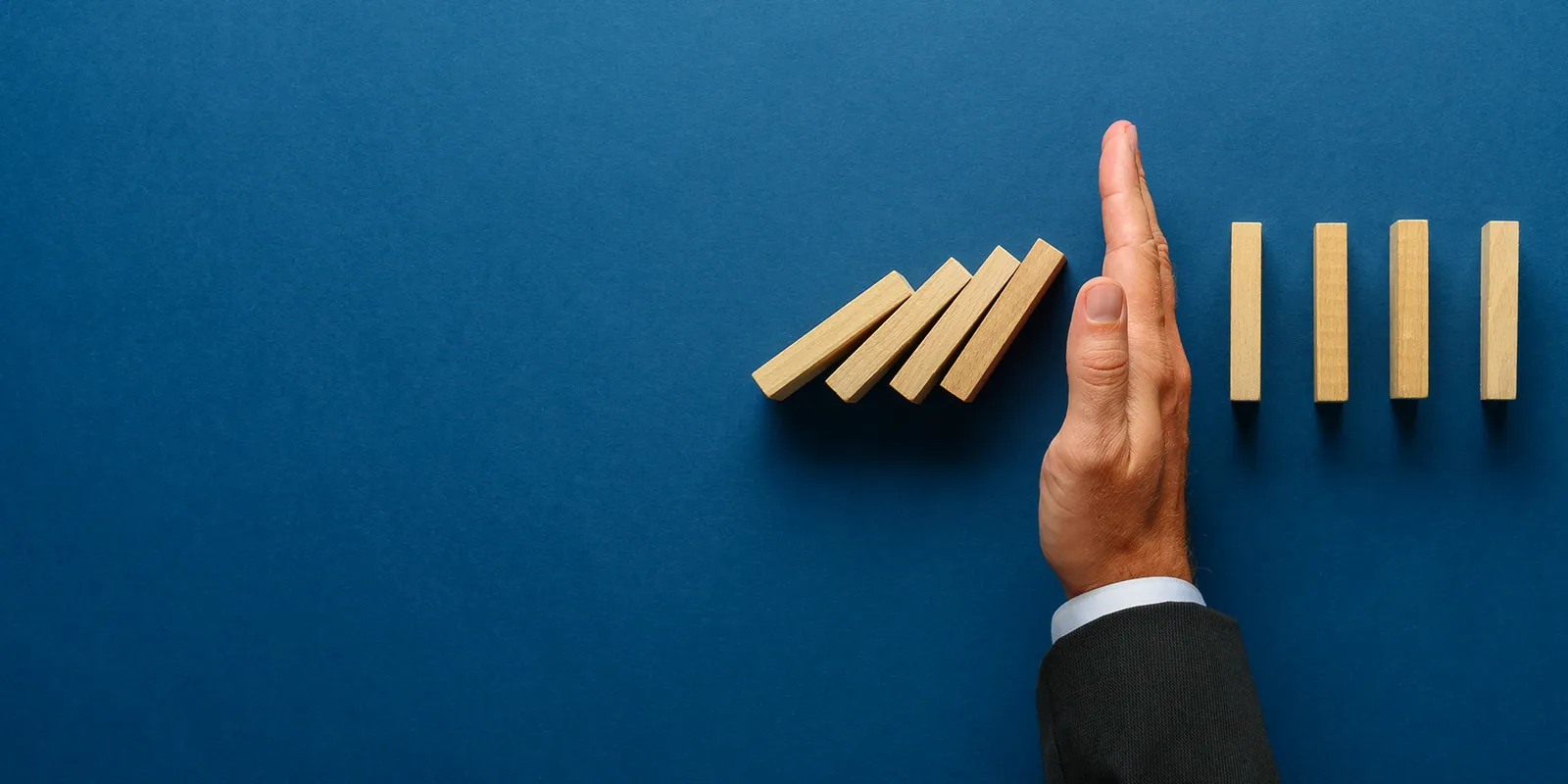 businessman stopping blocks on a blue background