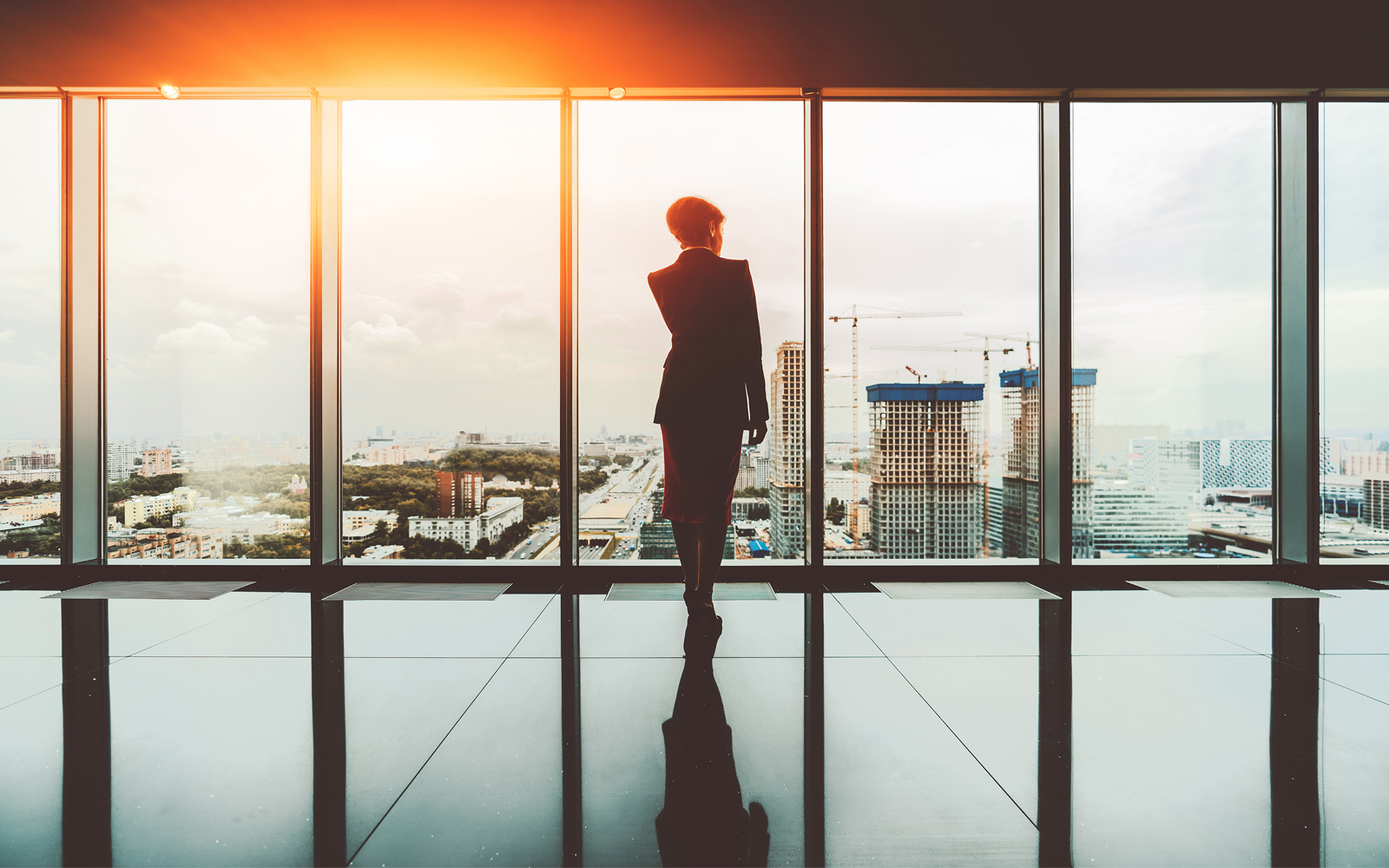 business woman looking out by the window