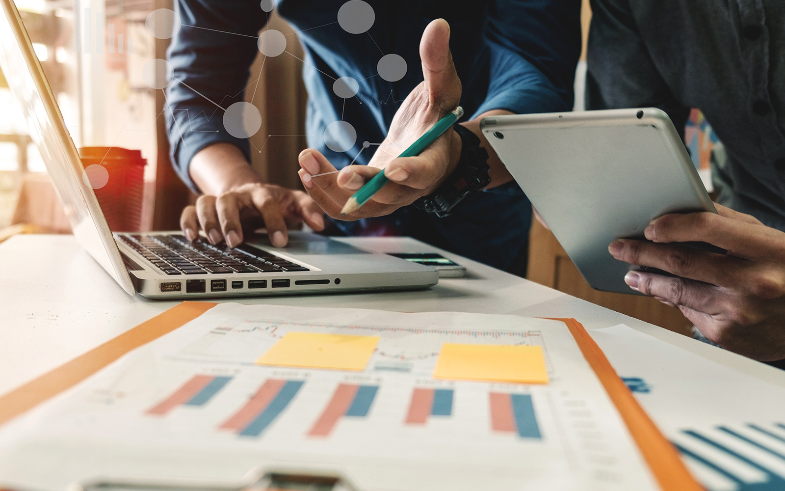 hands over a laptop and paperwork