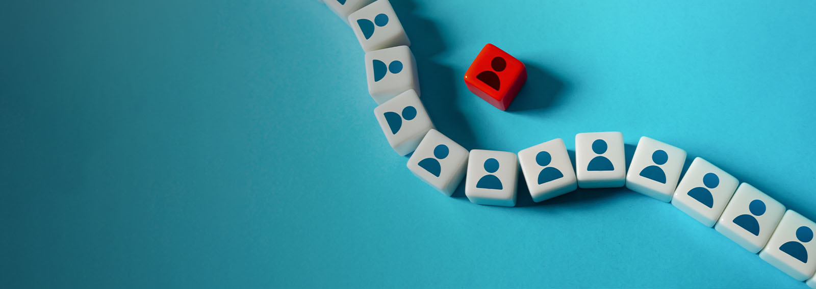 White icons of people with one red icon on a blue background