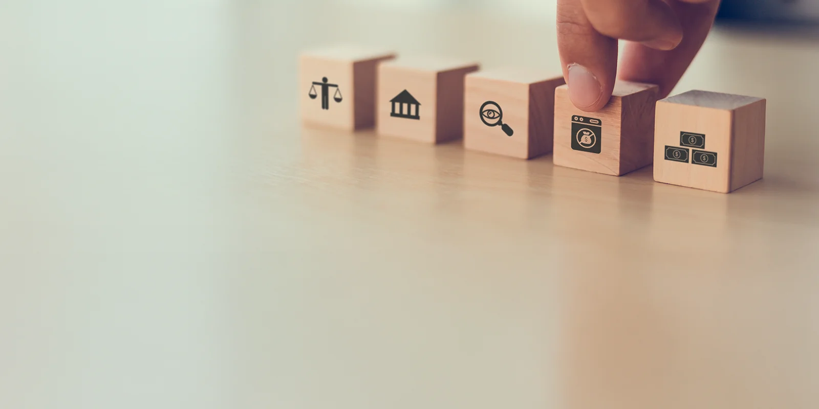 blocks with anti-money laundering icons lined up beside each other