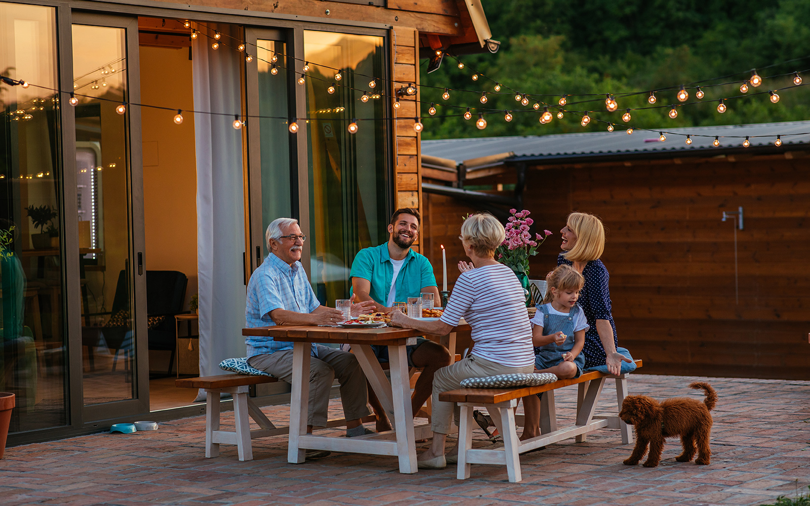 Heureuse famille joyeuse appréciant le repas ensemble dans le jardin