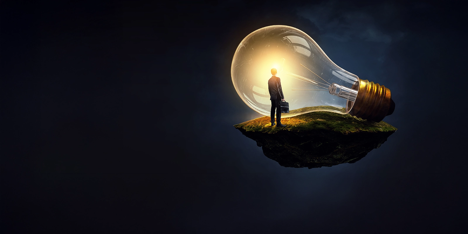 A person looking at a large lightbulb.