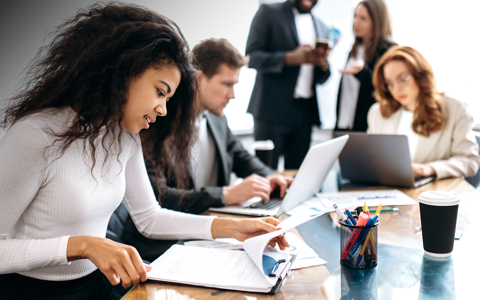 Focused business person working on corporate project at briefing meeting