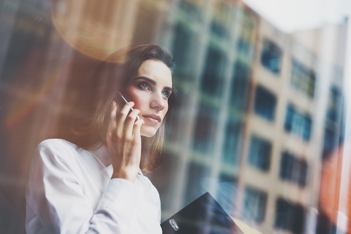 business women talking on a phone in an office